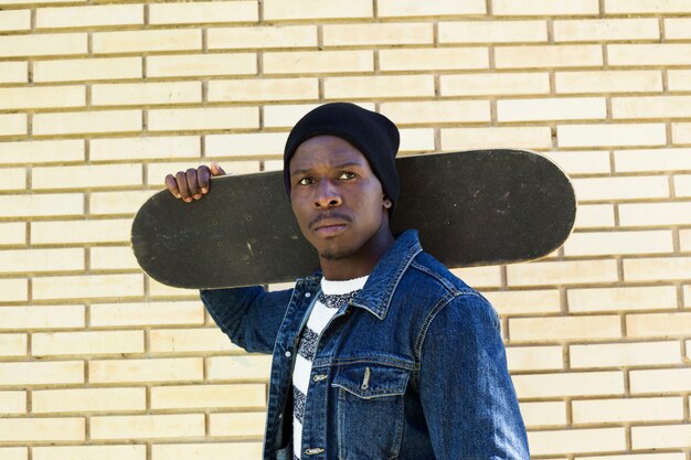 Man with skateboard in urban environment