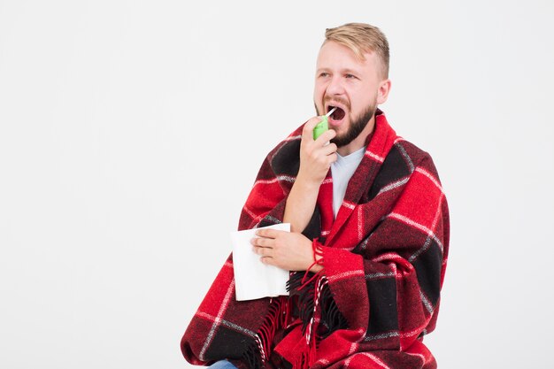 Man with spray for sore throat 