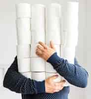 Free photo man with stack of toilet paper