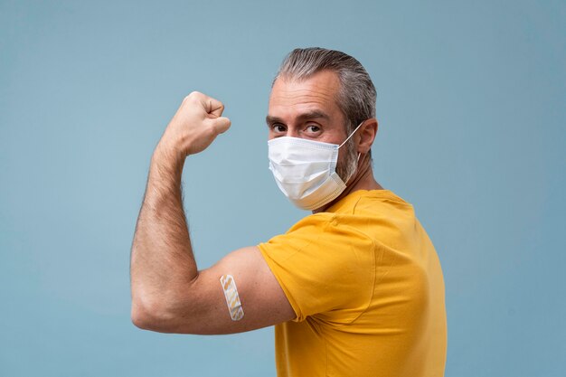 Man with sticker on arm after getting a vaccine