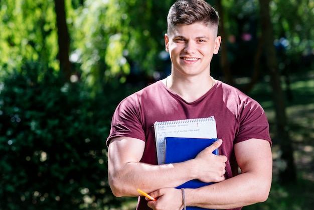 Man with study materials in park