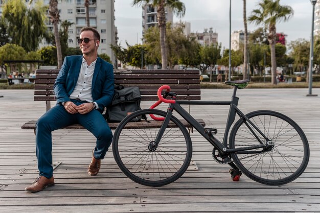 Man with sunglasses sitting on a bench