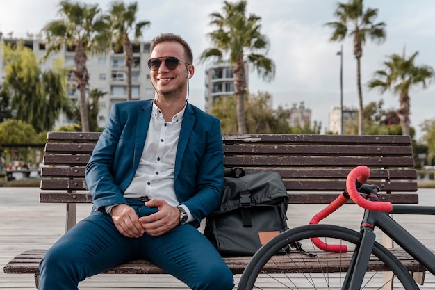 Man with sunglasses sitting on a bench