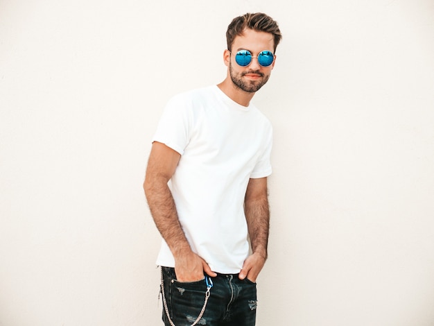 Man with sunglasses wearing white t-shirt posing