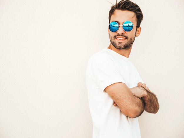 Man with sunglasses wearing white t-shirt posing