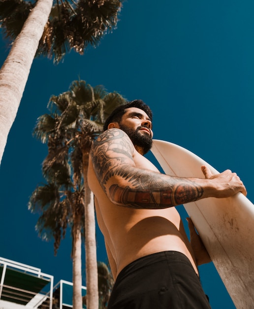 Man with surfboard on resort