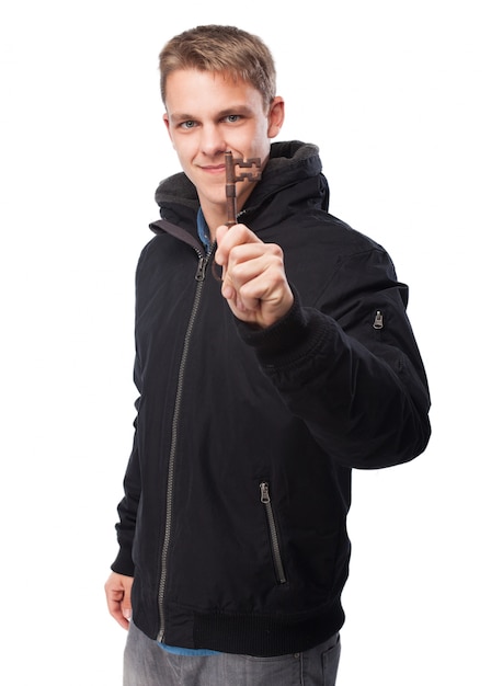 Man with sweatshirt holding an old key