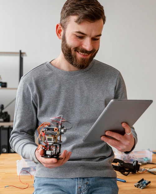 Man with tablet learning to make robot