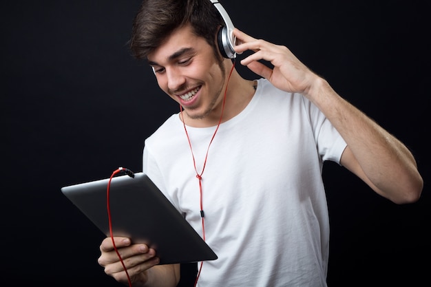 "Man with tablet listens to music"