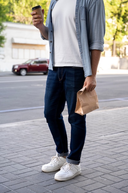 Man with takeaway food on the street