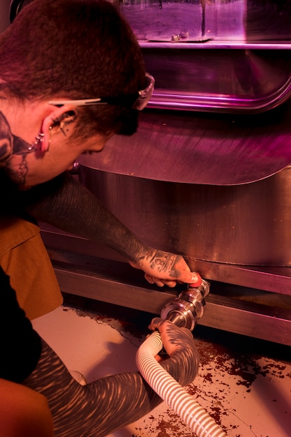 Man with tattoos producing craft beer