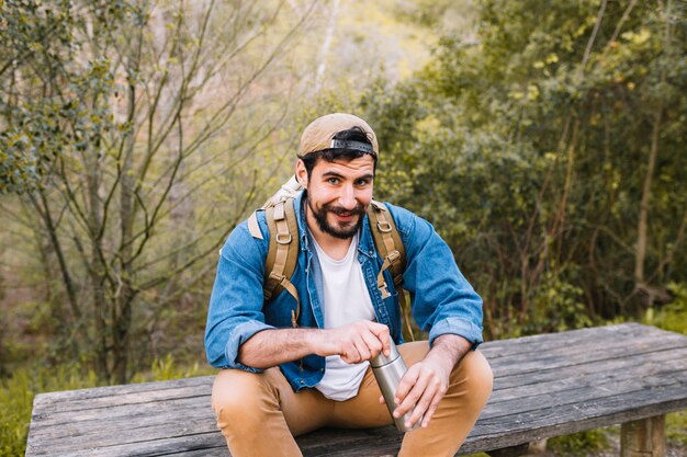 Man with thermos looking at camera