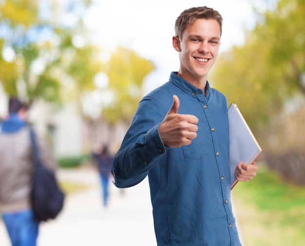 Man with a thumb up and a notebook