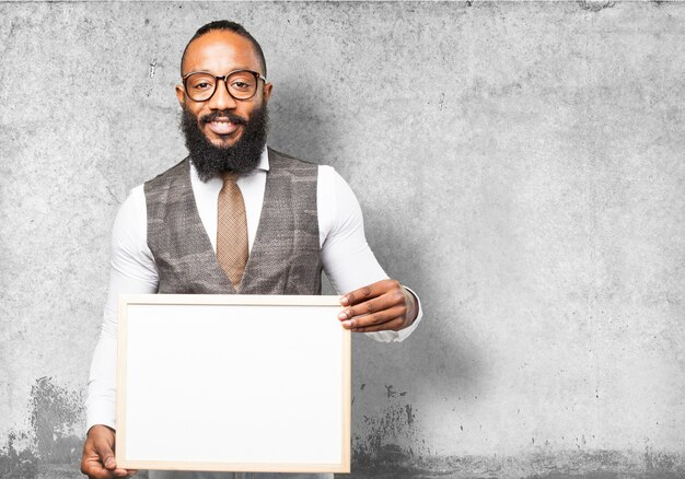 Man with tie holding a white board