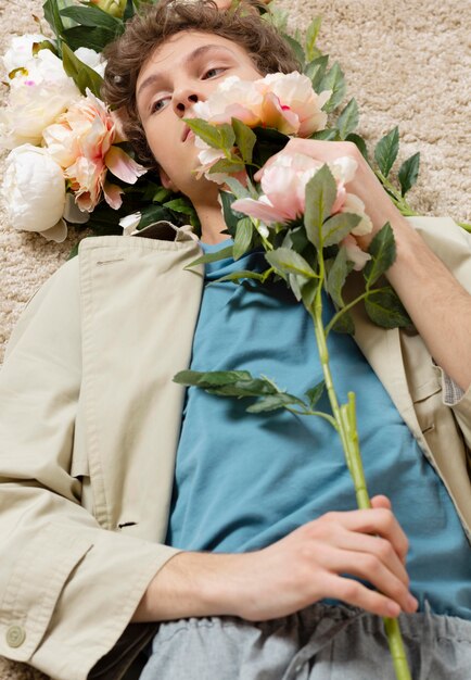 Man with trench coat holding flowers