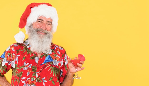 Uomo con camicia tropicale e cappello di natale con copia spazio