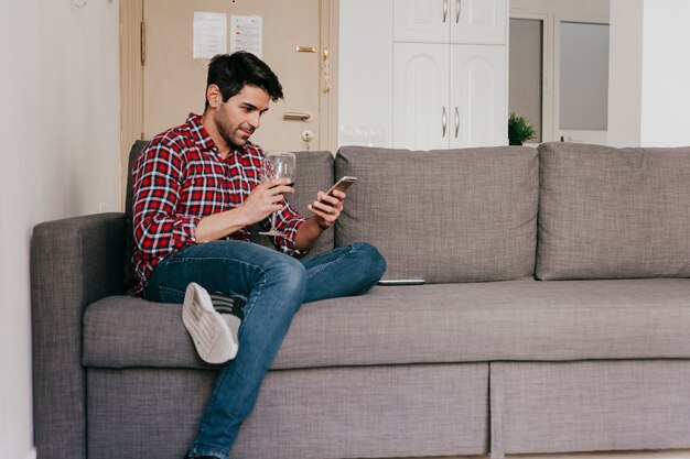 Man with wine on couch