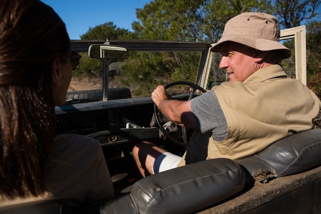 Free photo man with woman looking away while driving vehicle