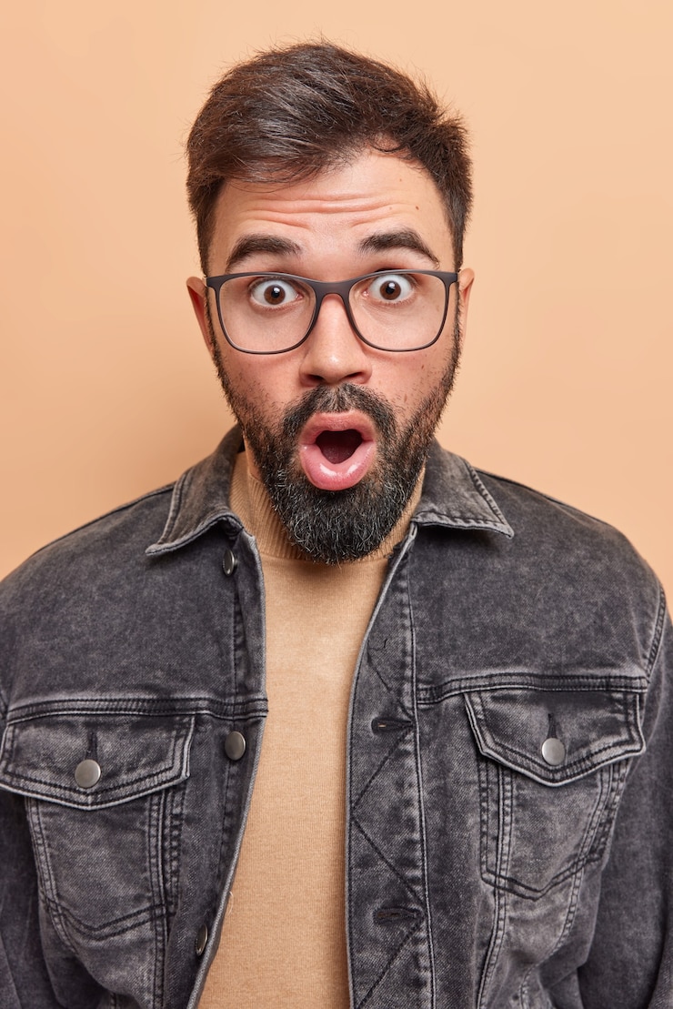 Free Photo man witnesses disaster keeps mouth wide opened remembers something bad wears spectacles gasps from wonder poses indoor says wow
