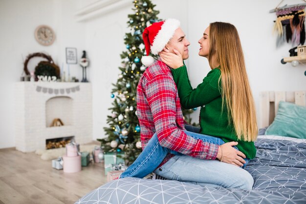 Man and woman on bed at christmas