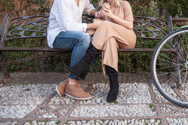 man and woman on the bench with bicycle