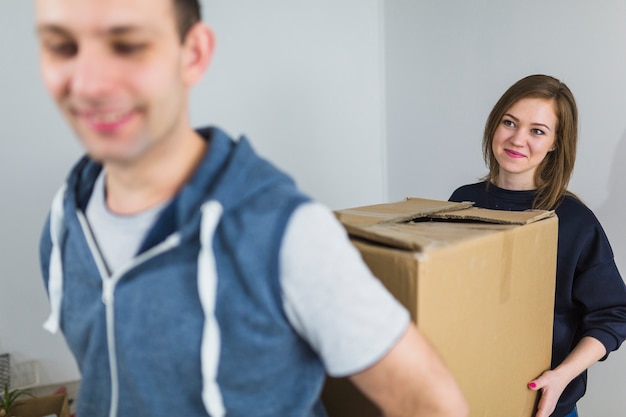 Free photo man and woman carrying box