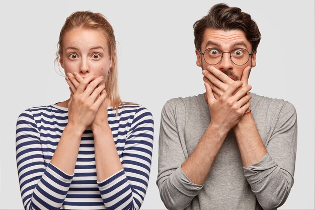 Man and woman in casual clothes posing