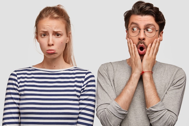 Man and woman in casual clothes posing