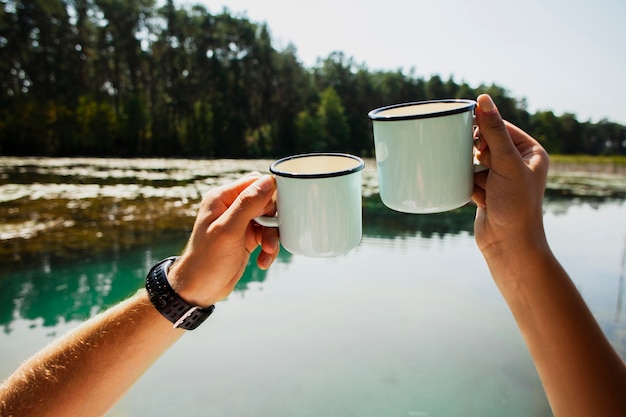 Free photo man and woman cheering about being outdoors together