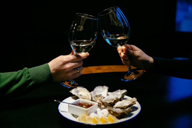 Man and woman do a cheers with champagne glasses. 