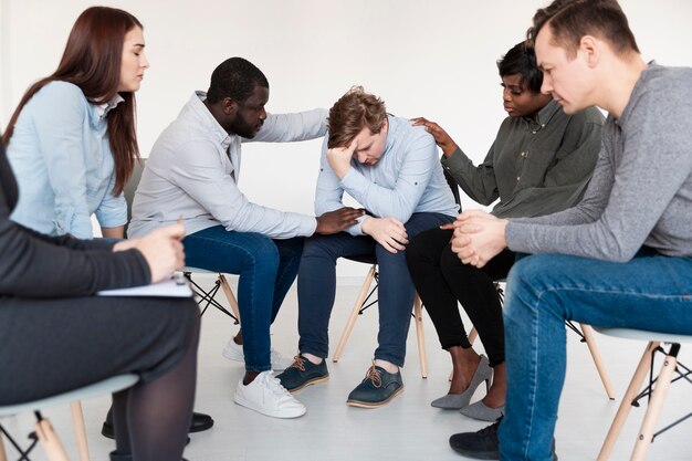 Man and woman consoling sad patient