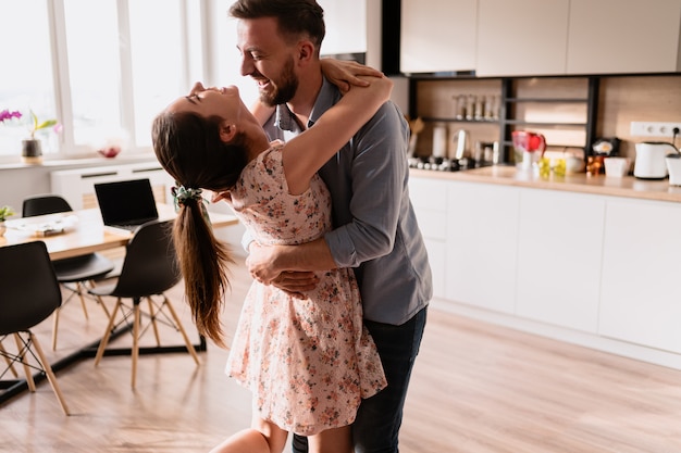 Man and woman dancing in a modern interior