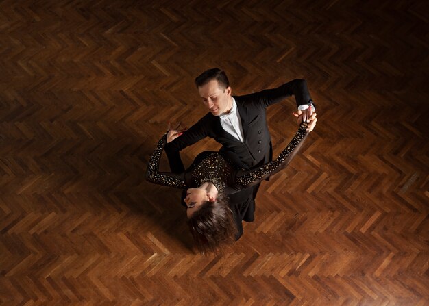 Man and woman dancing together in a ballroom scene