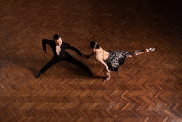 Man and woman dancing together in a ballroom scene