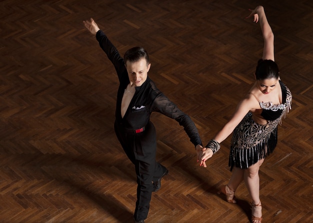 Man and woman dancing together in a ballroom scene