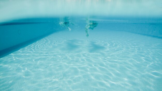 Man and woman diving in pool