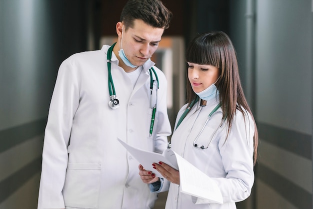 Man and woman doctors with documents