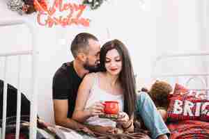 Free photo man and woman embracing on bed