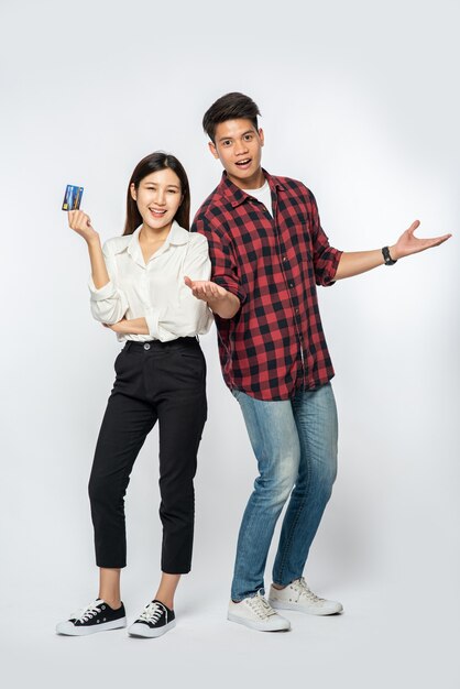 Man and woman enjoy using credit cards for shopping