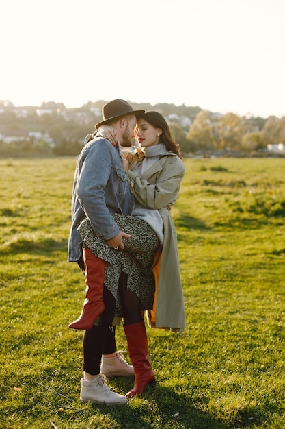 Man and woman in fashion clothes resting on a nature together