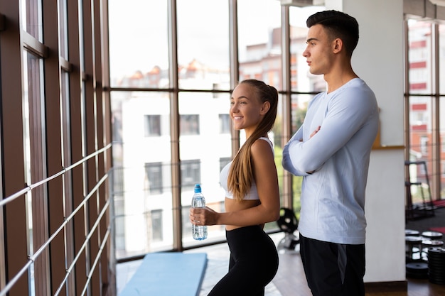 Man and woman at gym having break