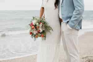 Free photo man and woman having a beach wedding