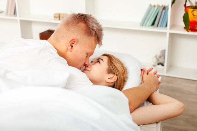 Man and woman having a fun time behind the sheets