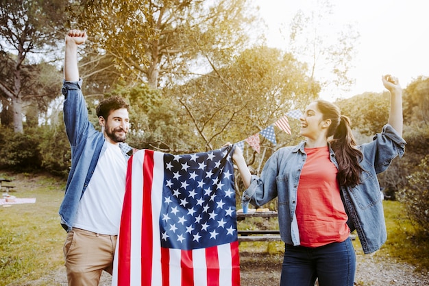 Man and woman holding flag