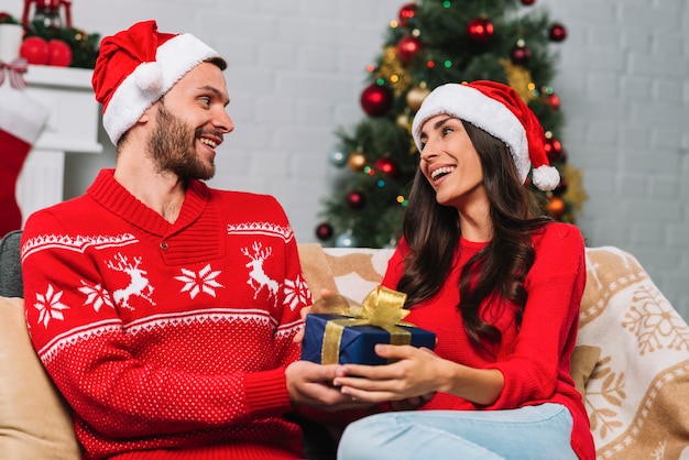 Man and woman holding present