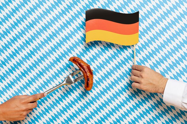 Man and woman holding sausage and flag