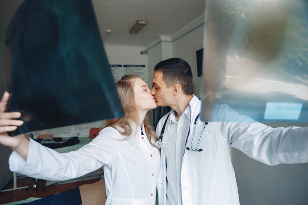 Man and woman in hospital gowns. Couple is conducting research.