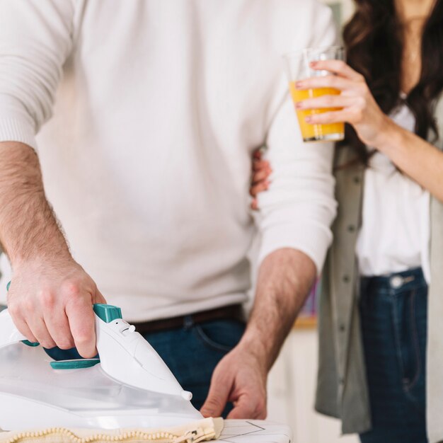 Man and woman ironing linen