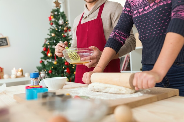 Man and woman kneading with a roller