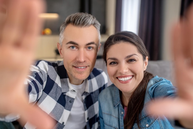 Man and woman looking at camera indoors